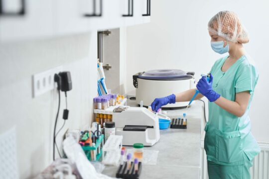 Female in medical suit working in laboratory